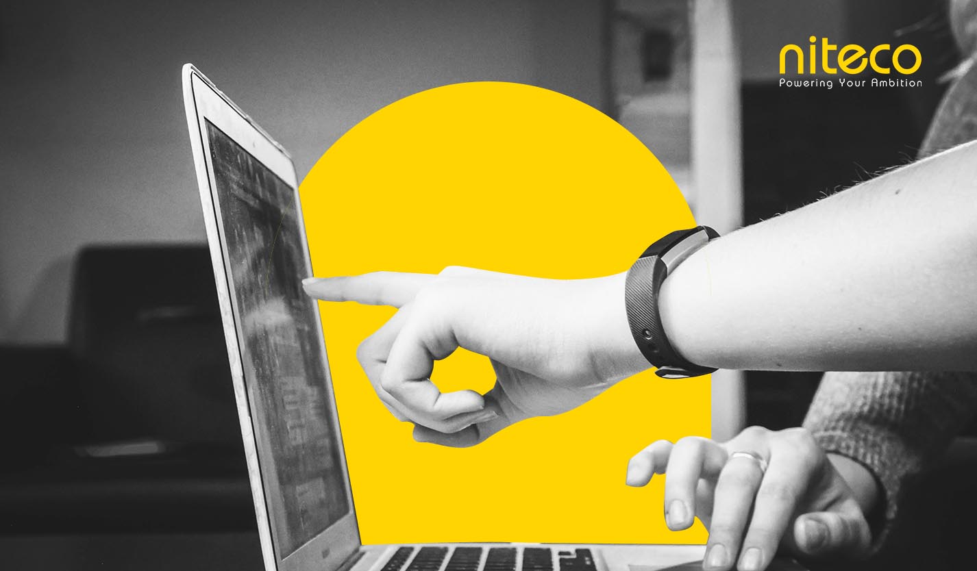Hand pointing at laptop screen with Niteco branding and yellow design element
