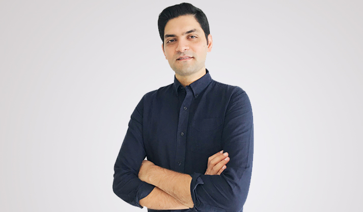 Confident professional man in black shirt with arms crossed on white background