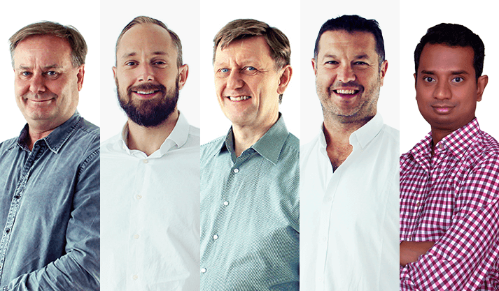 Team of five diverse professionals smiling and dressed in business casual attire
