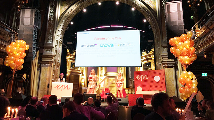 Award ceremony with Partner of the Year presentation in a grand venue with balloons