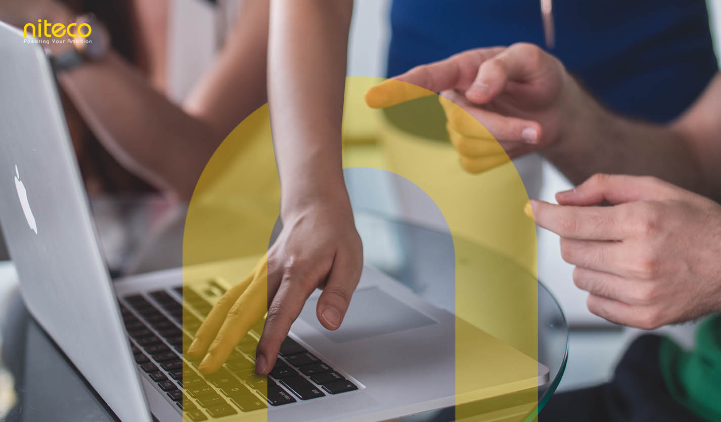 Hands collaborating on laptop keyboard, teamwork and innovation at Niteco