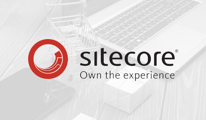 Sitecore logo with shopping cart and laptop representing digital commerce solutions