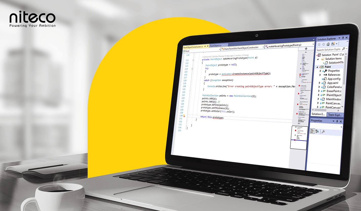 Laptop screen showing PaintObject.cs coding in Niteco software development environment